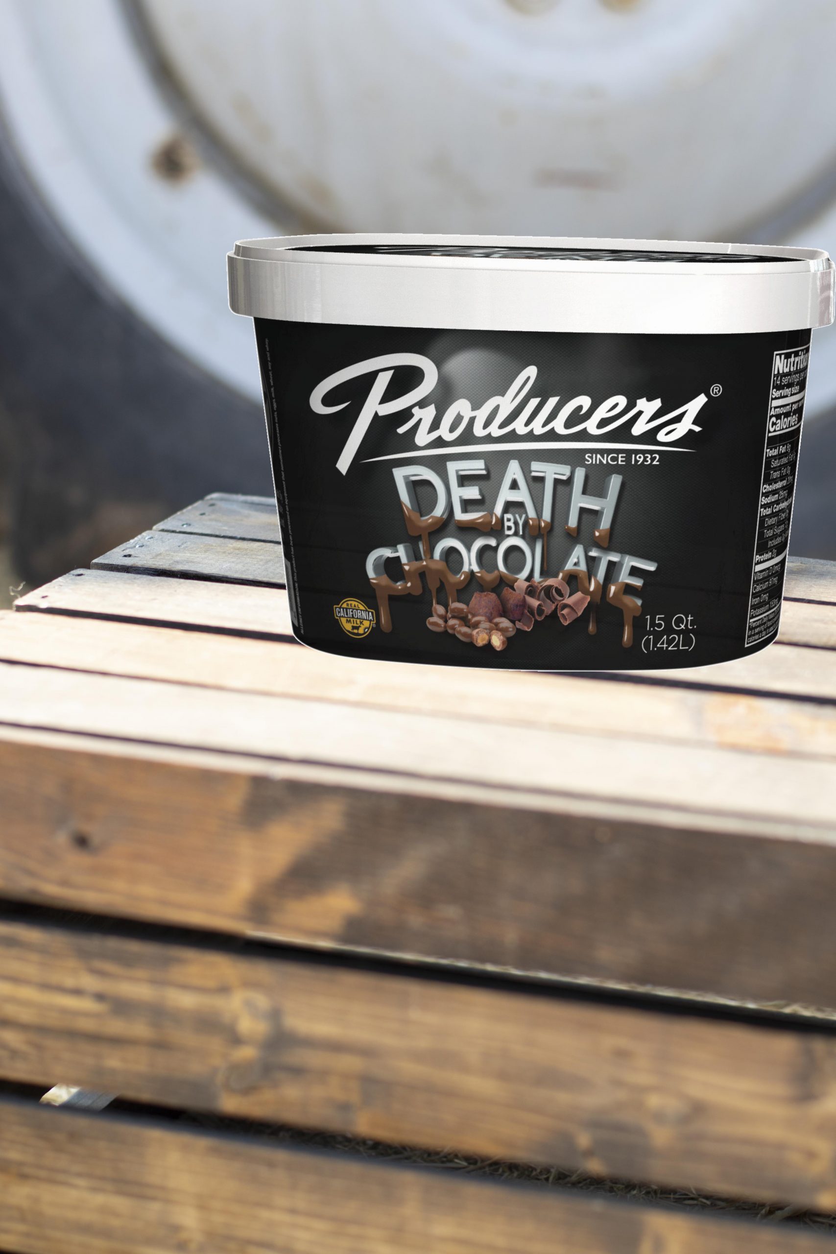 DeathByChocolate_Farm Death By Chocolate Producers Ice Cream sitting on wood in front of a tractor.