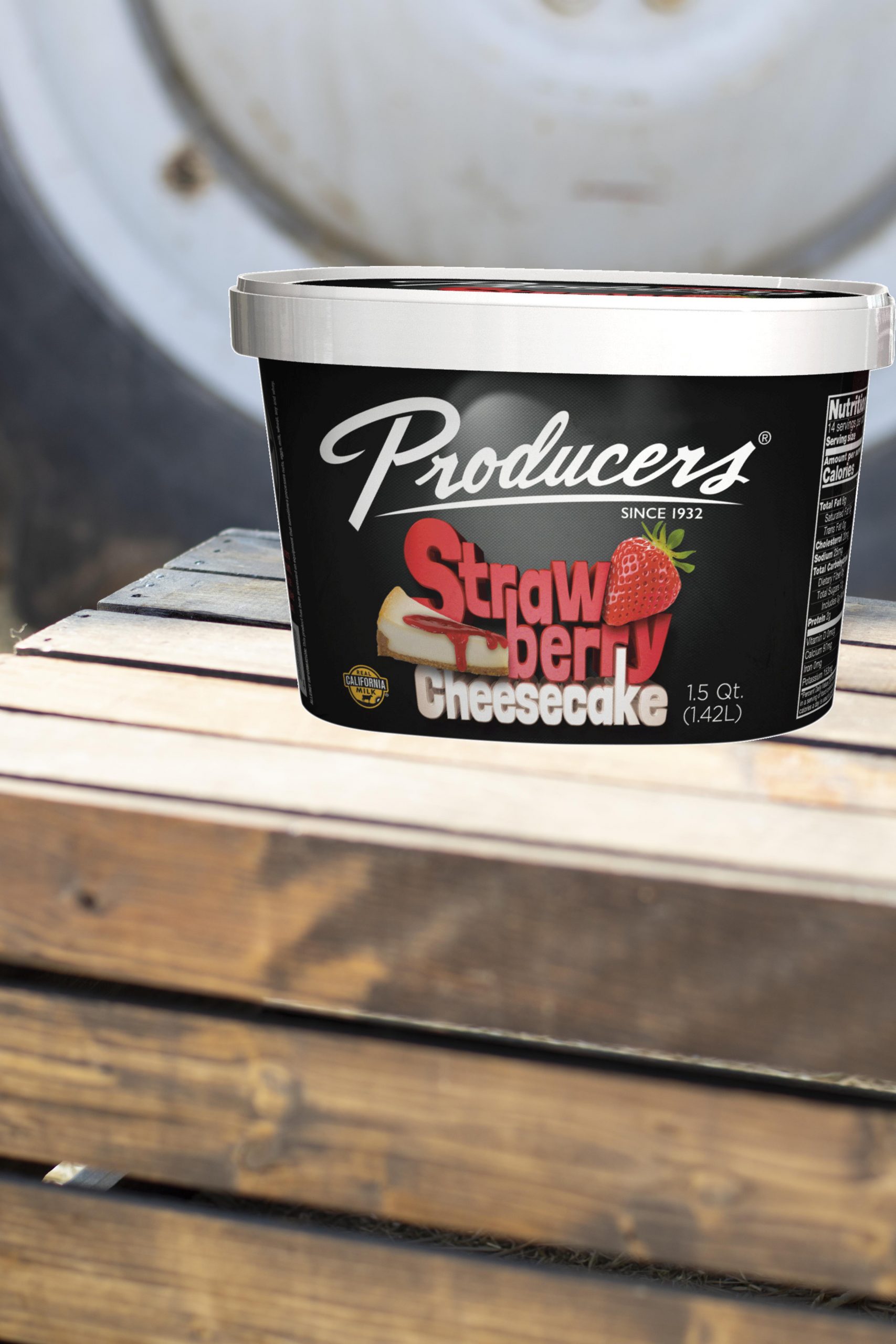 StrawberryCheesecake_Farm Strawberry Cheesecake Producers Ice Cream sitting on wood in front of a tractor.