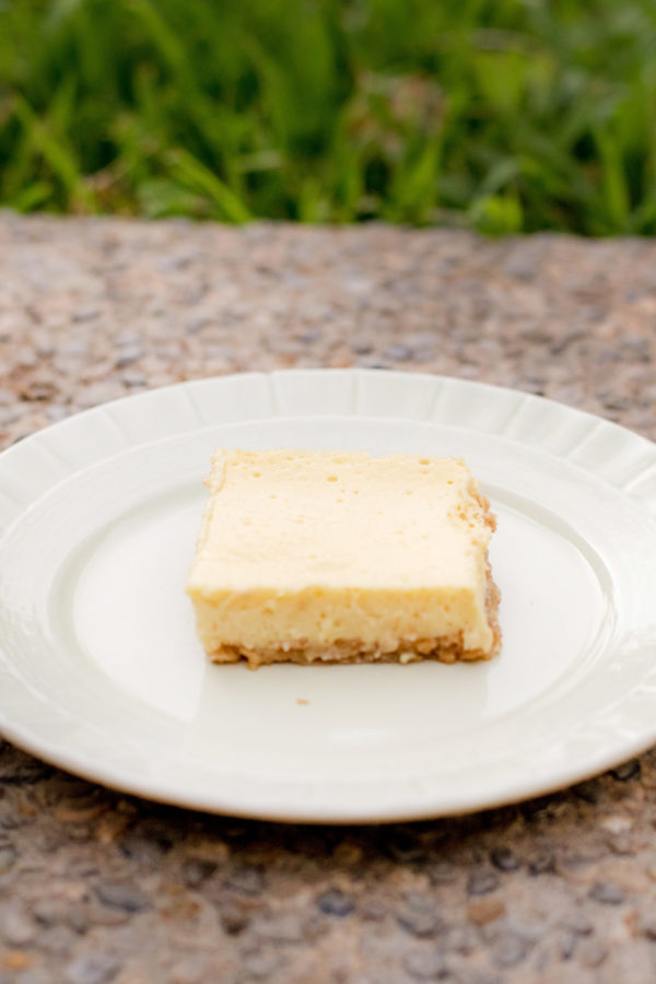 lemonbar Sour cream lemon bar on a green plate outside in the backyard