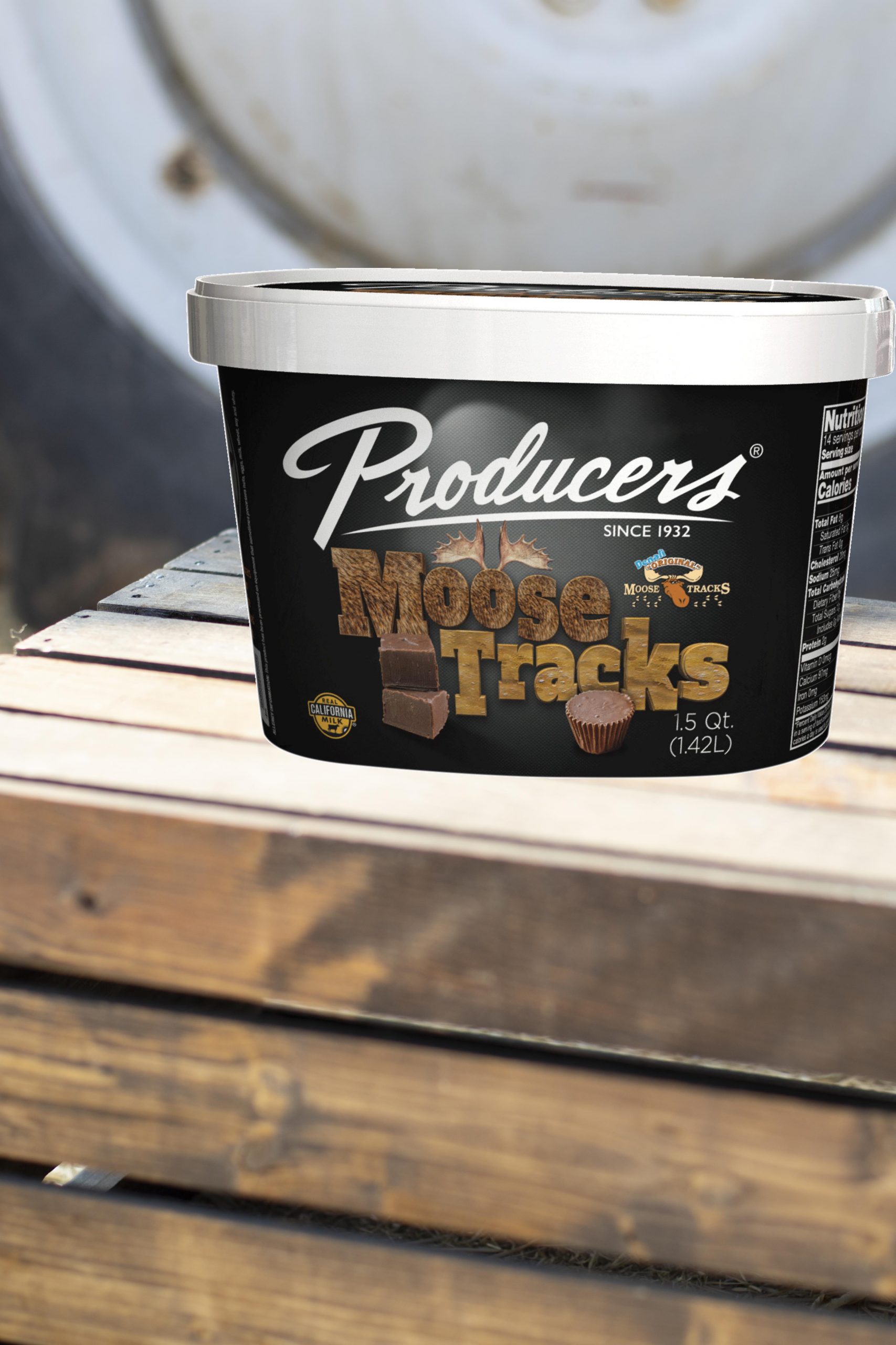 MooseTracks_Farm Moose Tracks Producers Ice Cream sitting on wood in front of a tractor.